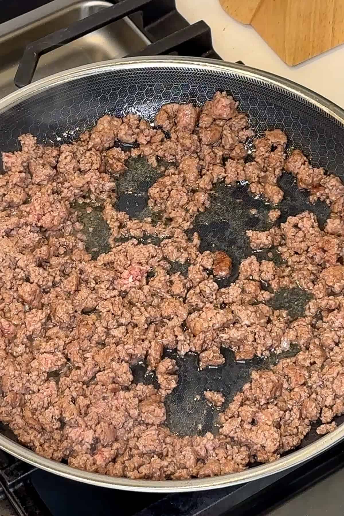 Ground beef being browned in a skillet.