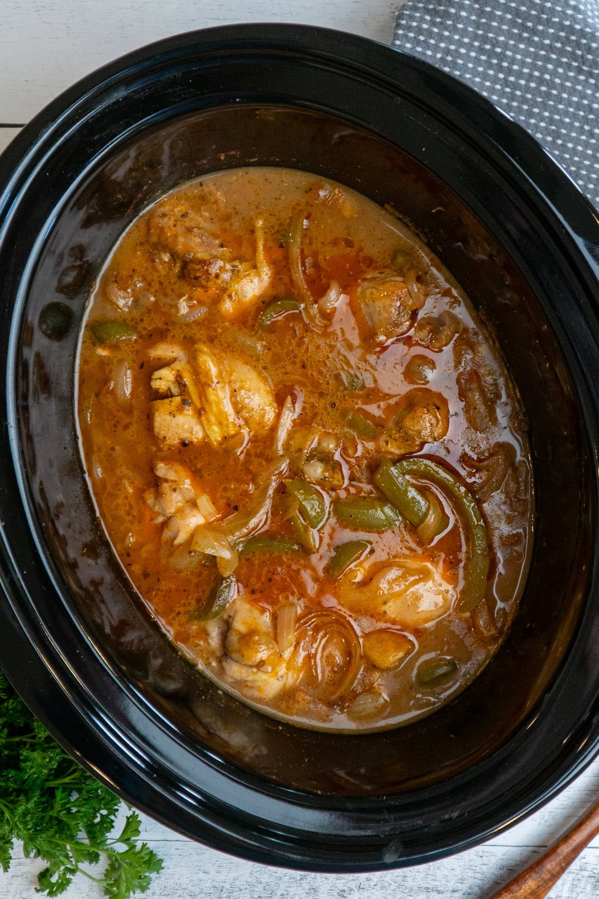 Smothered chicken legs in a crockpot.