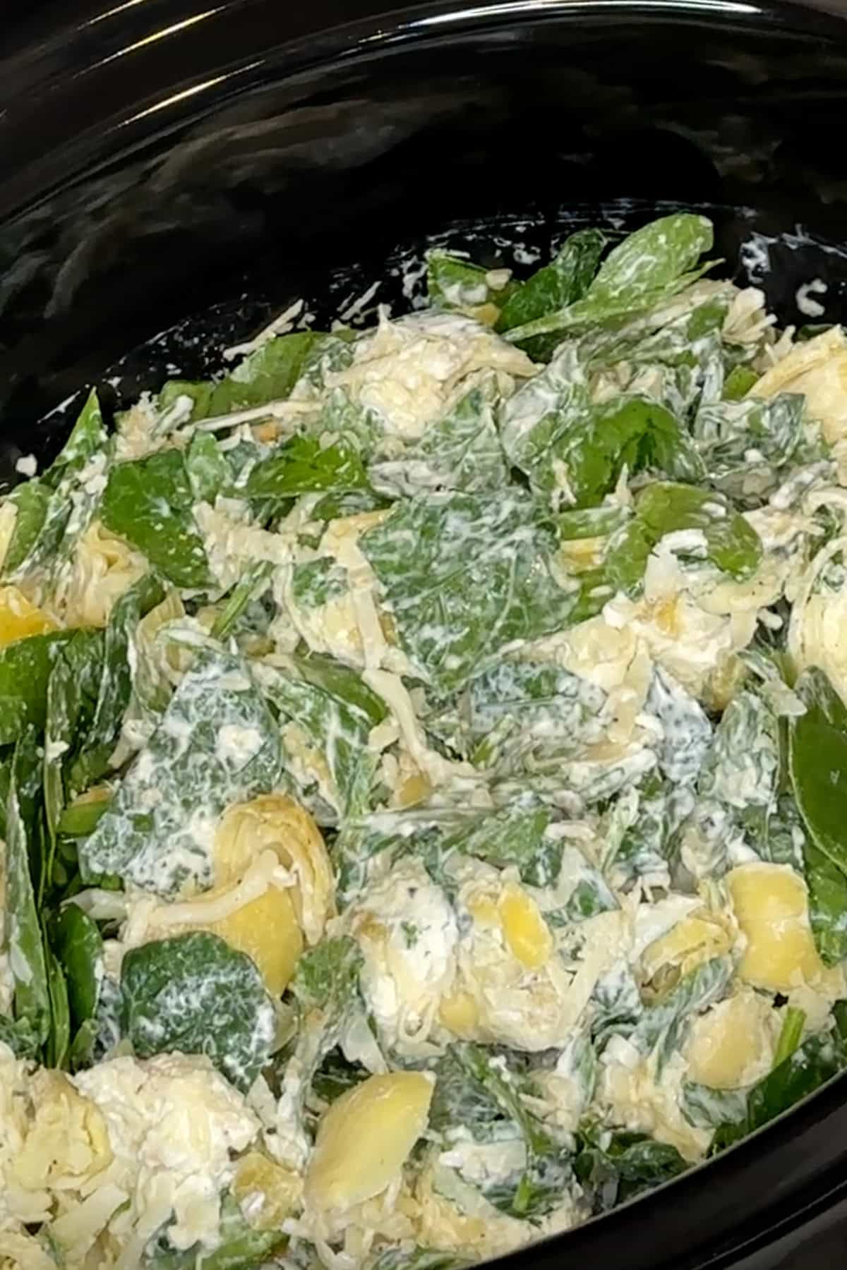 Spinach artichoke dip ingredients mixed together and ready to be cooked.