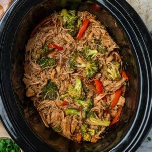 Crock Pot teriyaki chicken with a side of rice and green onions.