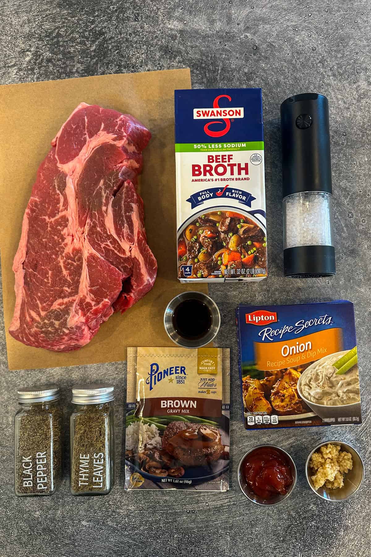 Ingredients to make Manhattan beef on a gray countertop.