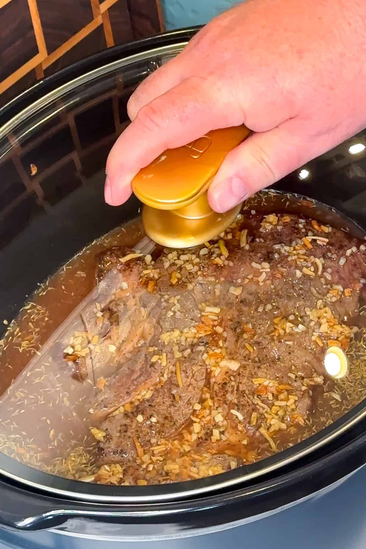 Beef Manhattan being cooked in a crock pot.
