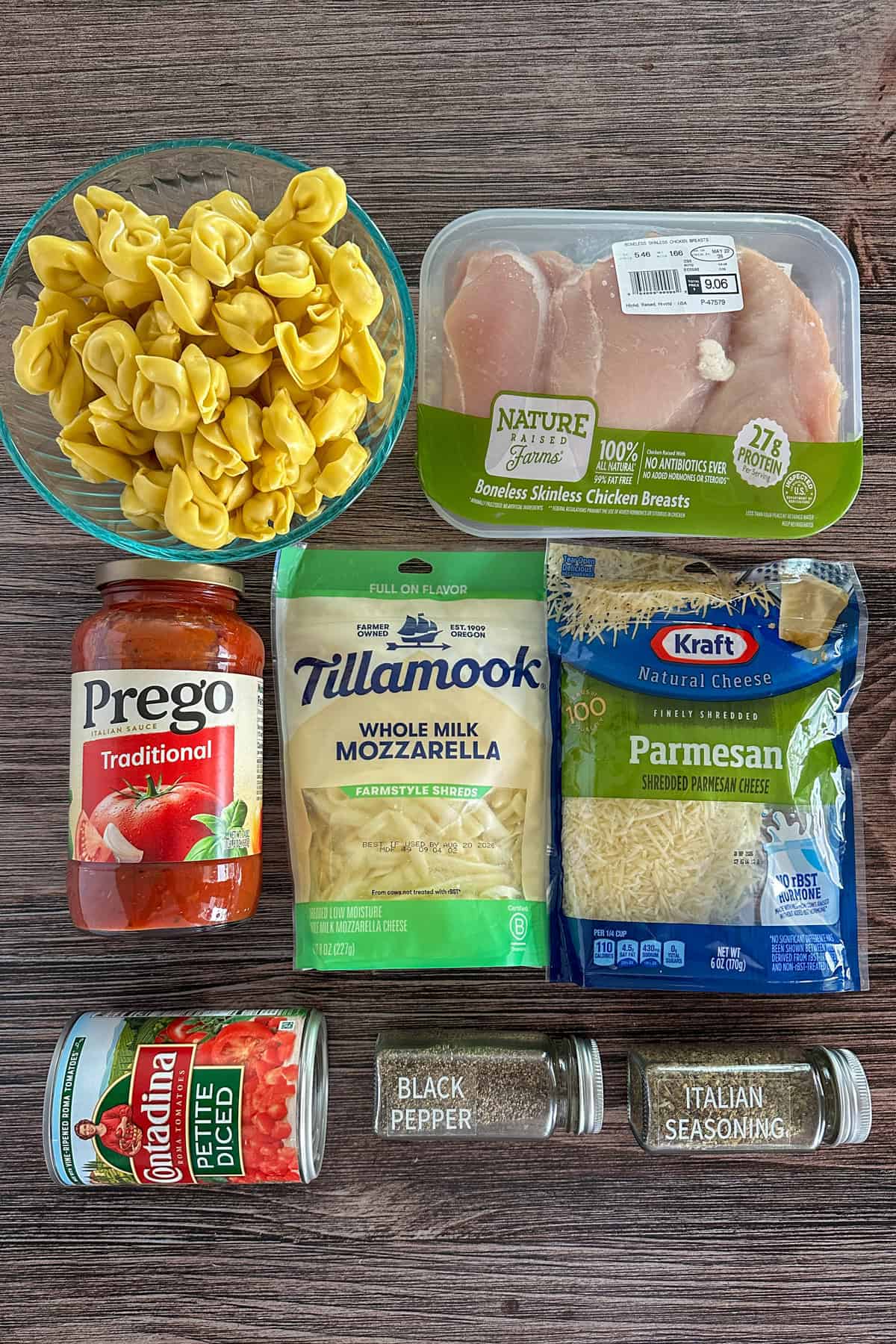 Ingredients to make chicken parmesan tortellini on a wooden table.
