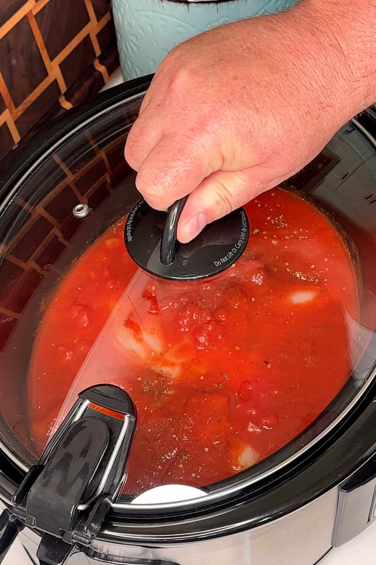 Chicken and sauce cooked in a crock pot.