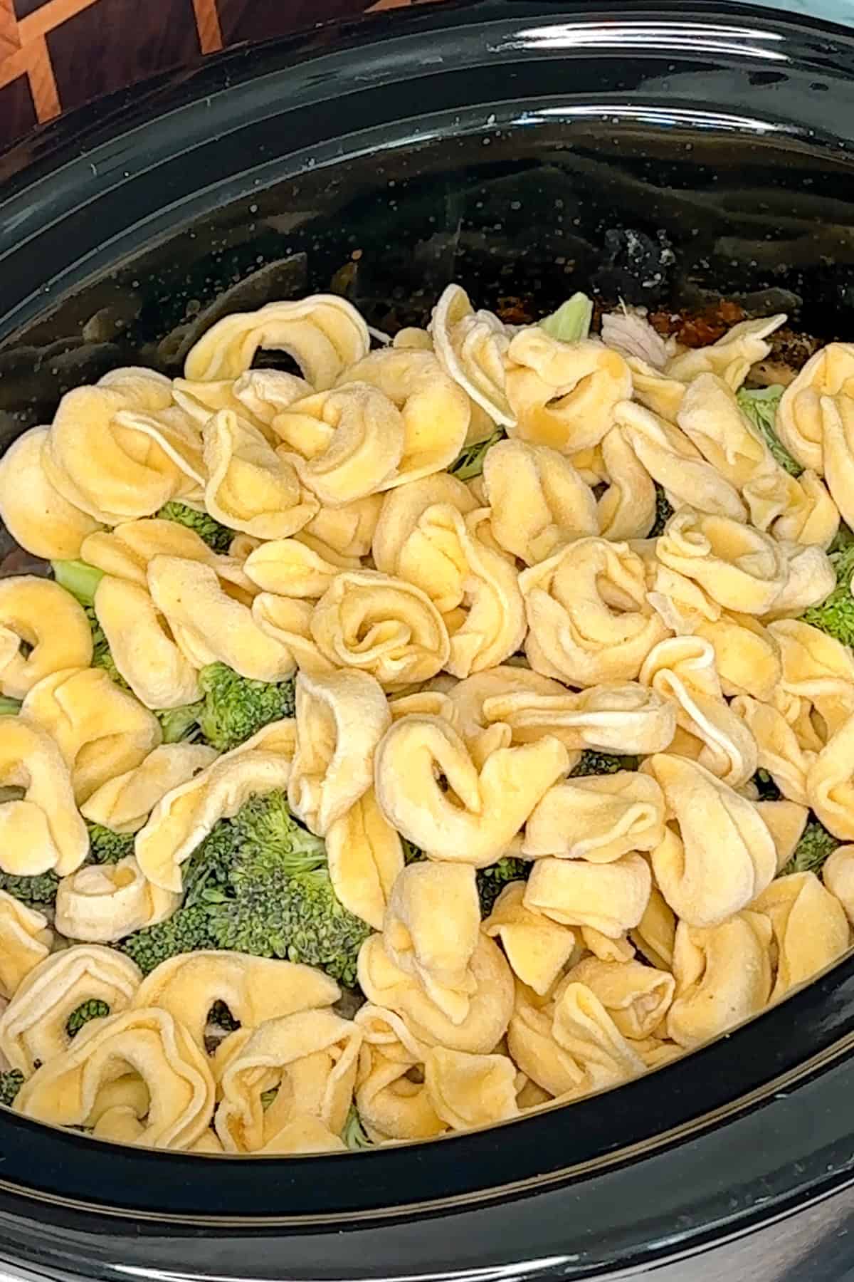 Frozen broccoli and tortellini added to the chicken and sauce.